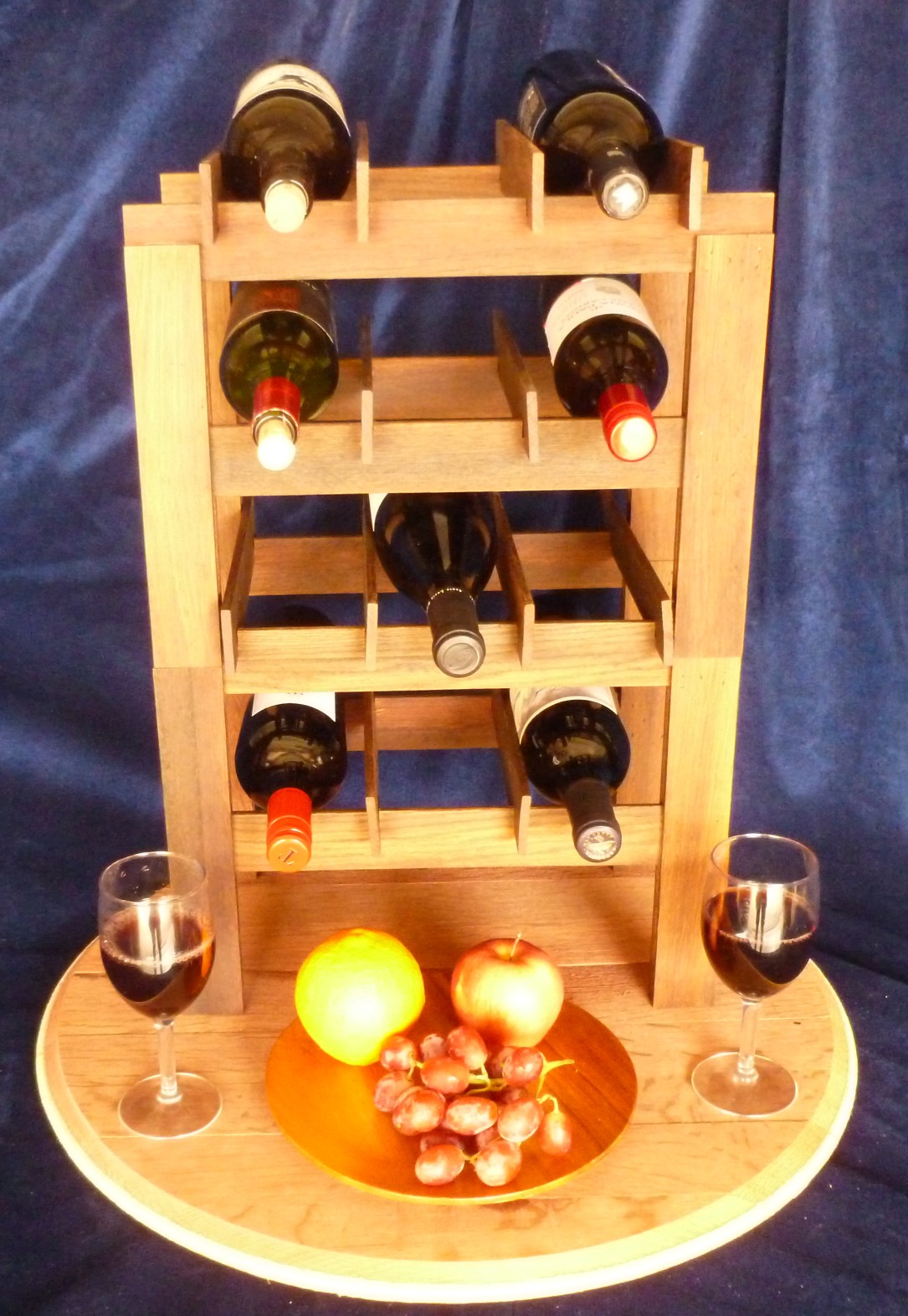 Modular wine rack units stacked on barrel top base